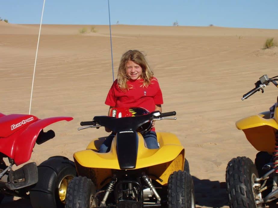 A young girl riding an ATV 