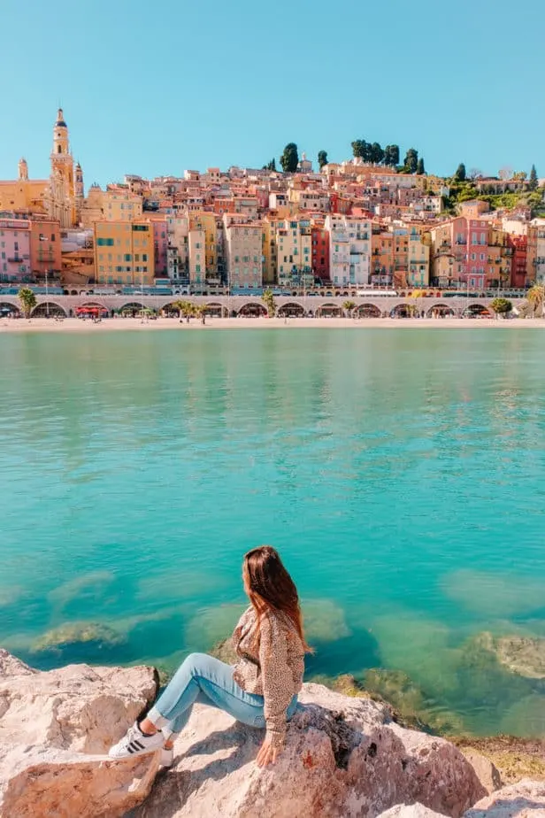 girl sitting in front of Menton, France view
