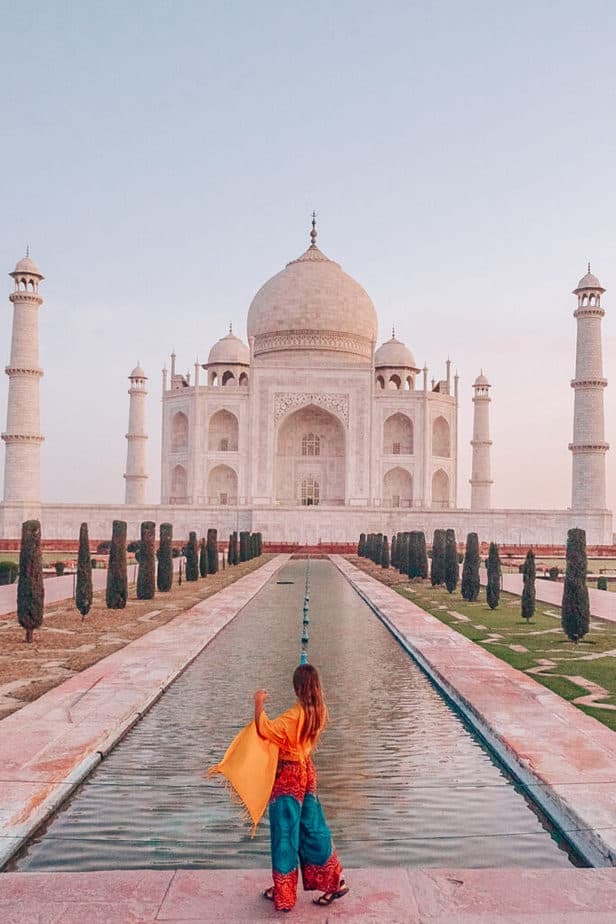 girl standing in front of the Taj Mahal in India