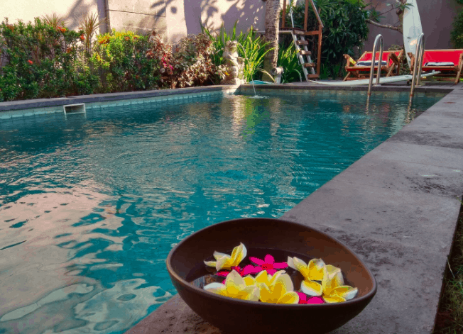 bowl of flowers in front of a pool in Bali