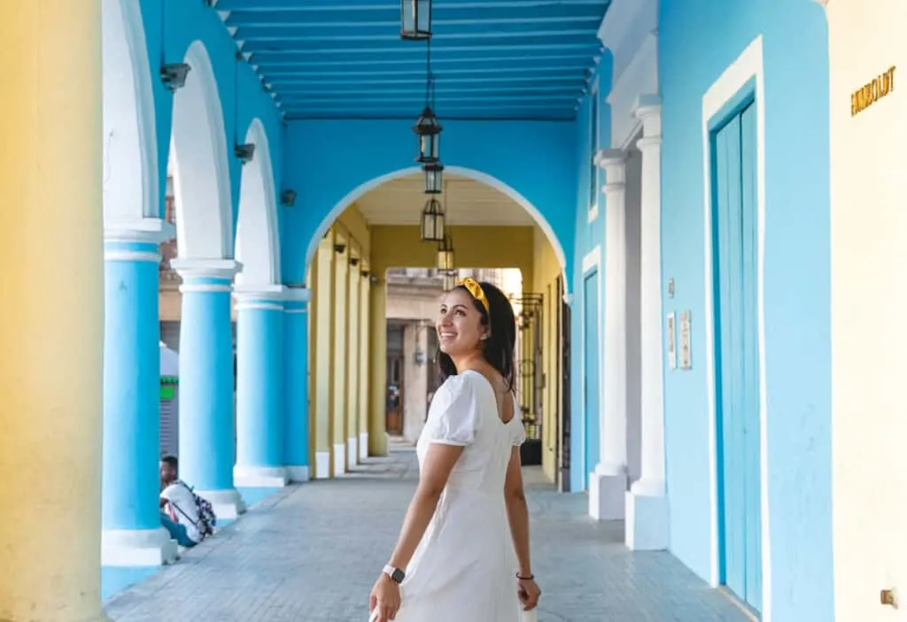 girl walking through blue building 