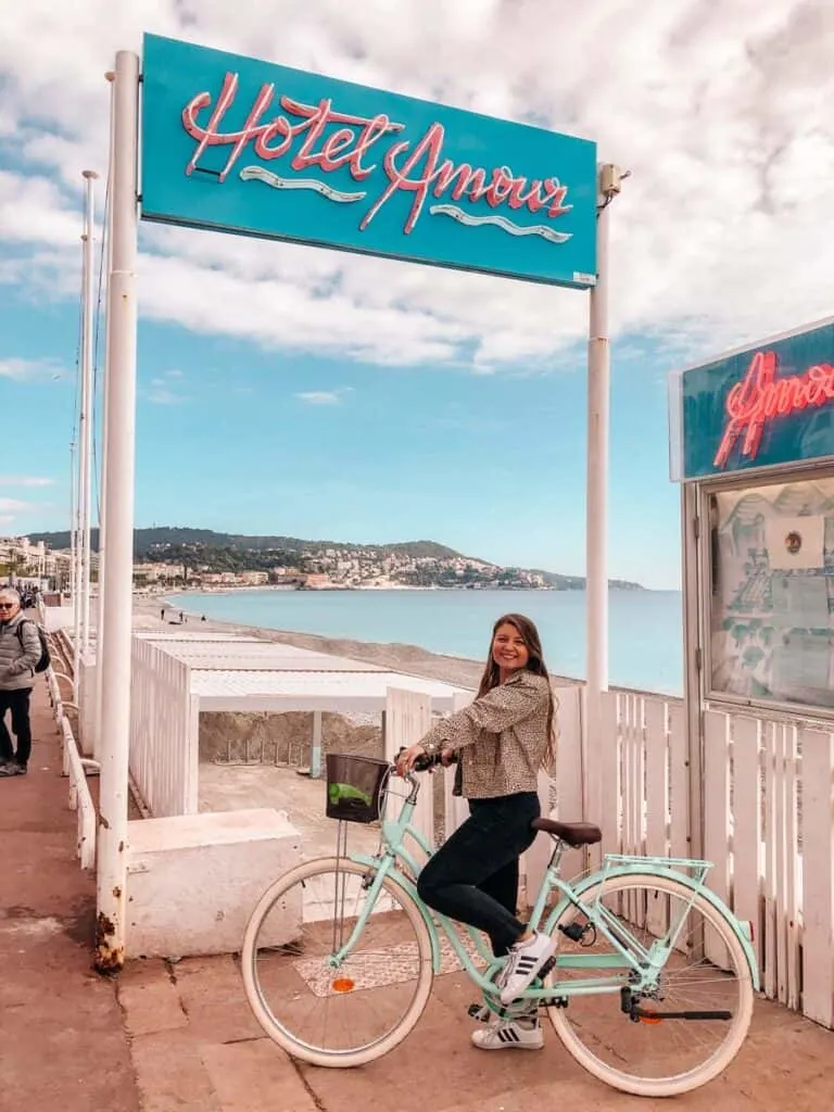 girl standing with bike on Promenade in Nice, France
