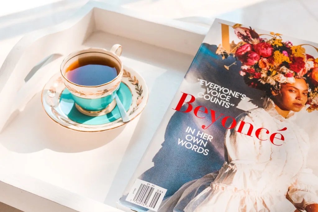 a cup of tea with a magazine cover of Beyonce