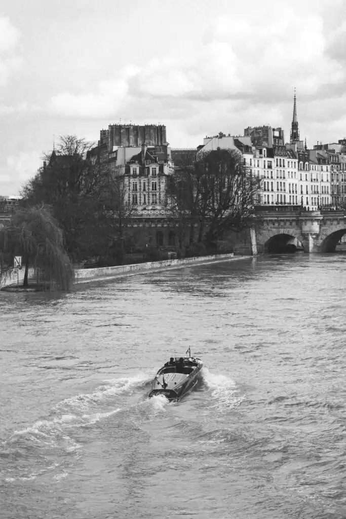 a boat riding in the Seine in Paris