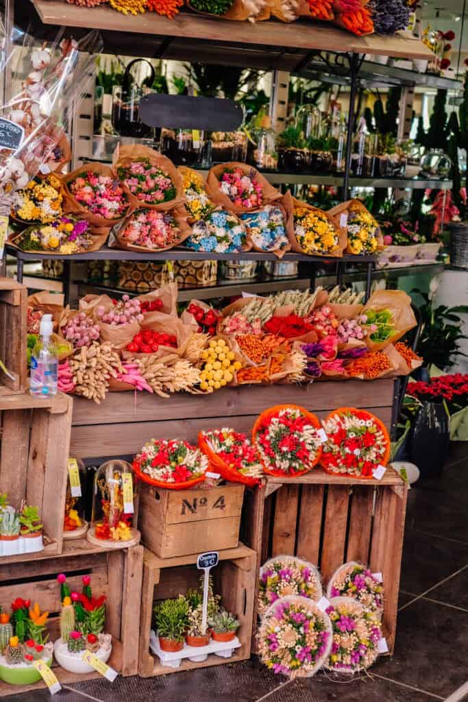 A market stall overflowing with colorful bouquets of flowers